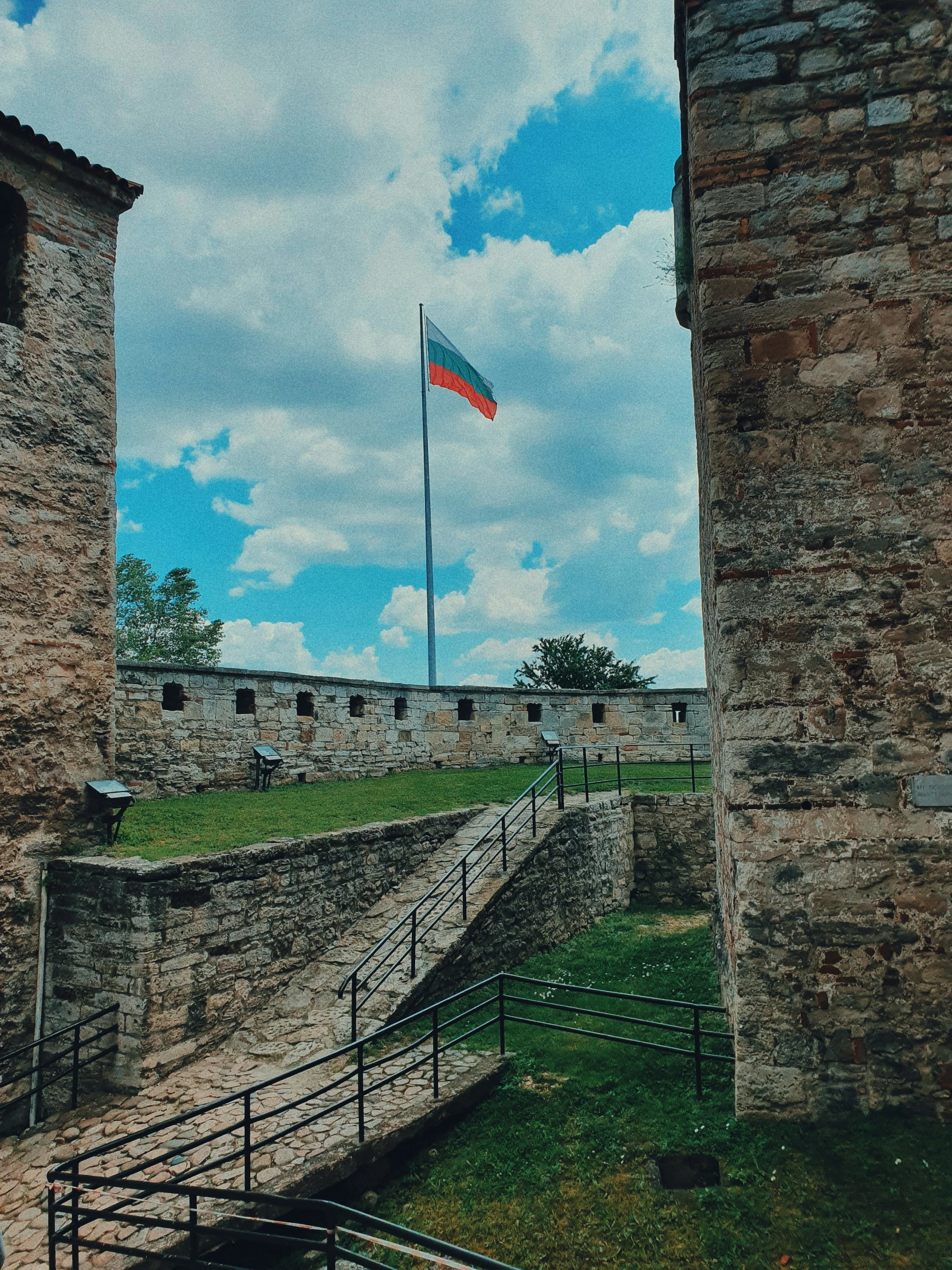 an old building with a large flag flying from it's top