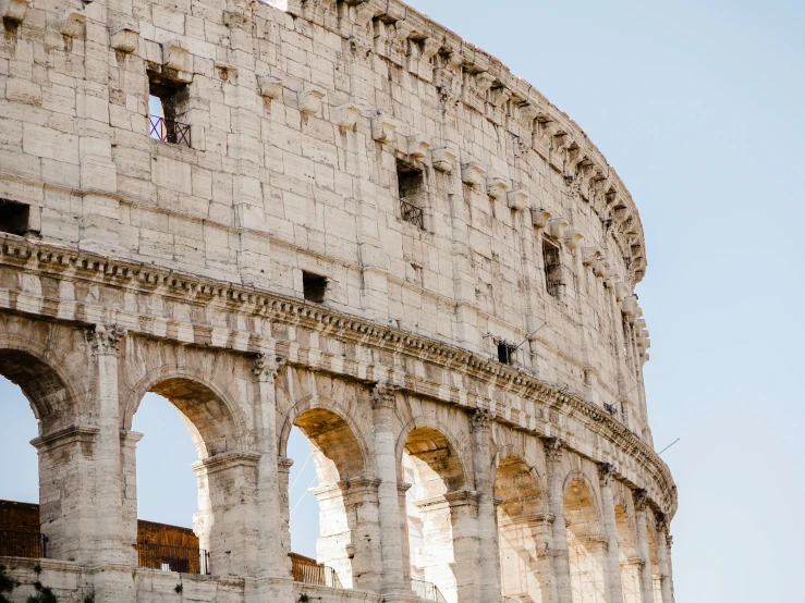 some arches are built into the side of a very old building