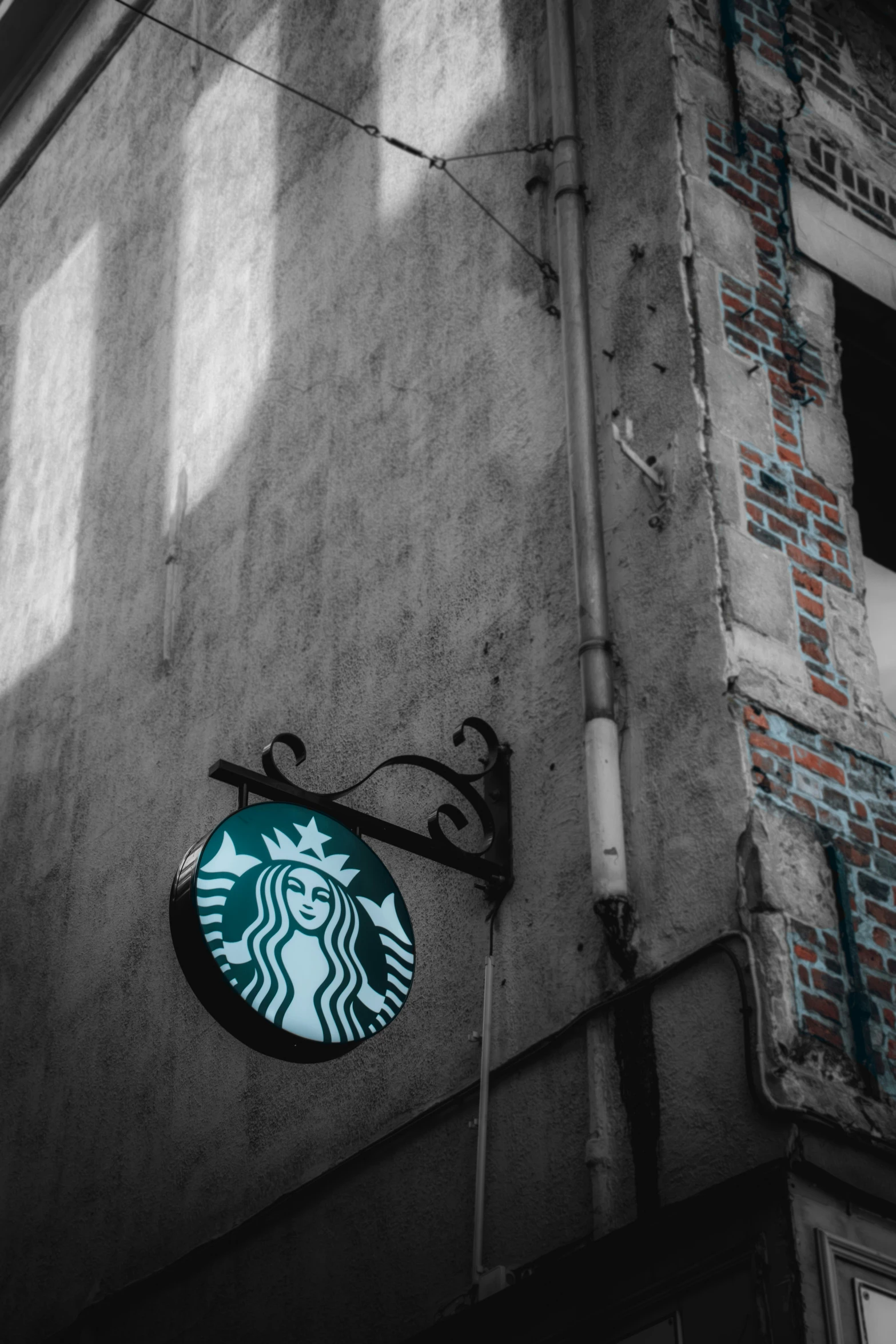 a black and white po of the starbucks logo on a building