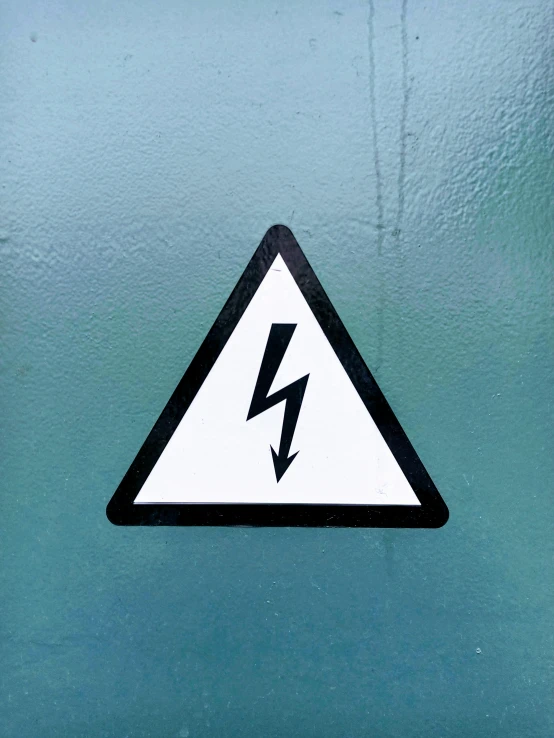 a white and black sign with a lightning symbol on it