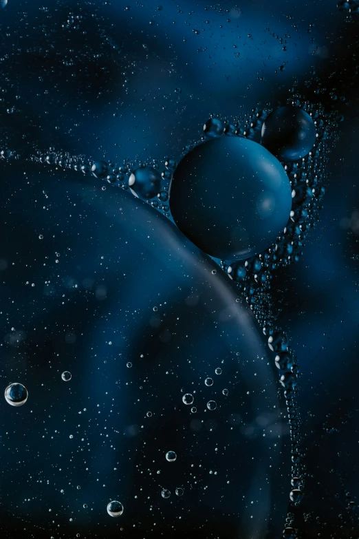 water bubbles on a blue and black background