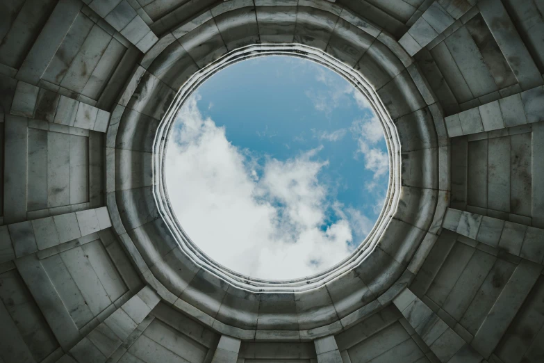 a view from the inside of a large concrete structure looking up into the sky