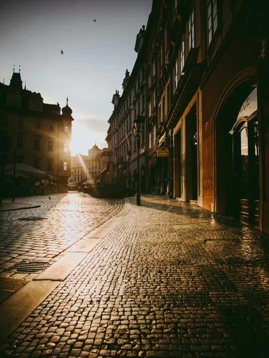 a street scene with focus on an umbrella and brick road