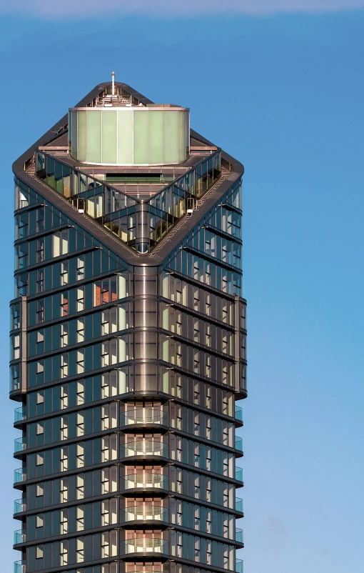 a high rise office building with a tall, triangular shaped top