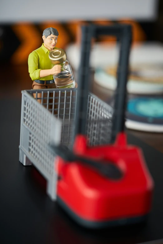 small toy man sitting inside a basket on a table