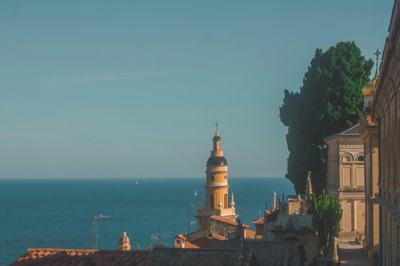 a city with an image of a building next to the ocean