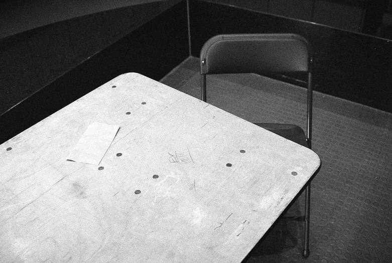 the white square table has a metal chair