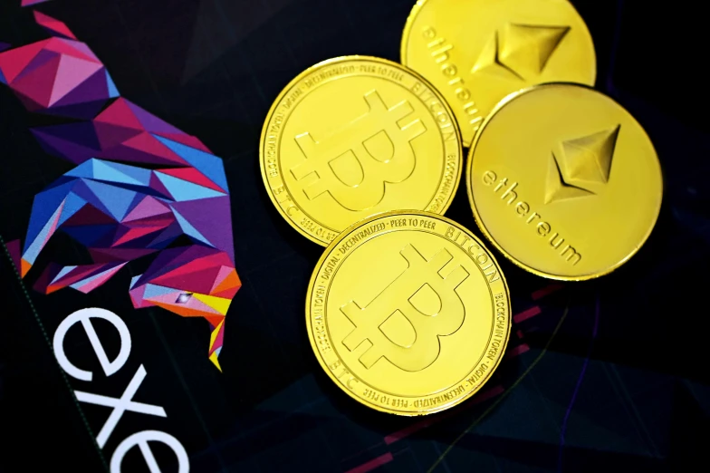 three gold canadian coins on top of a colorful background