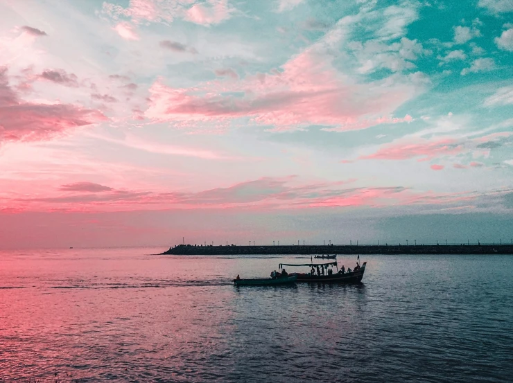 three people in a boat going through the ocean