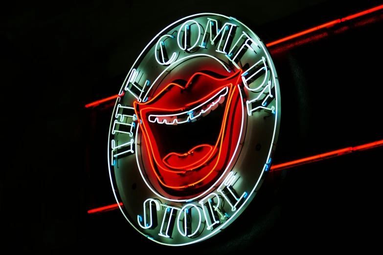 a large round neon sign hanging from the side of a wall