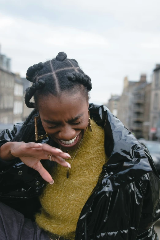 a woman with cornrows talks on her phone