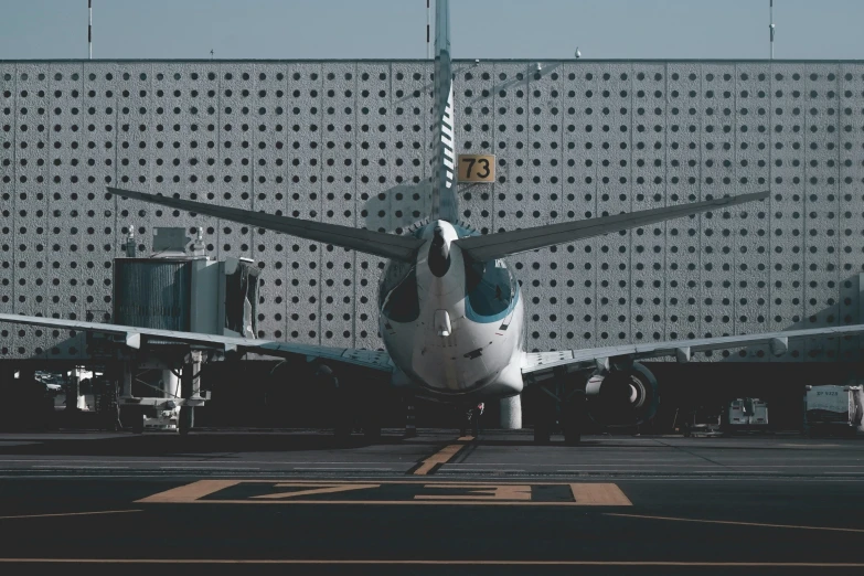 a passenger jet parked next to a large building