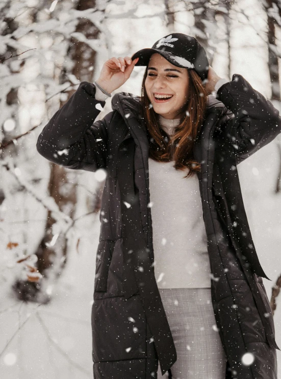 woman laughing and standing outside in the snow