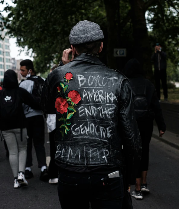 a man is wearing graffiti on his jacket