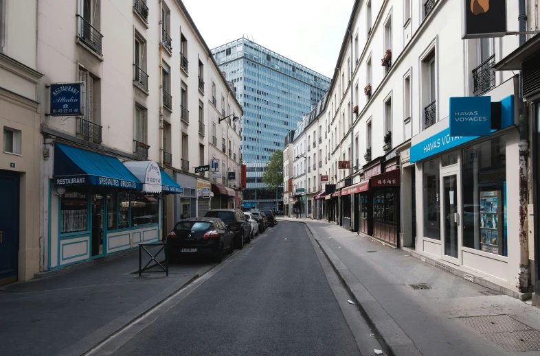 several buildings and cars along the streets of a city