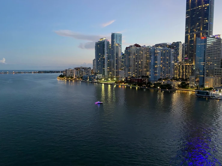 view from the water with a large body of water and skyscrs in the distance