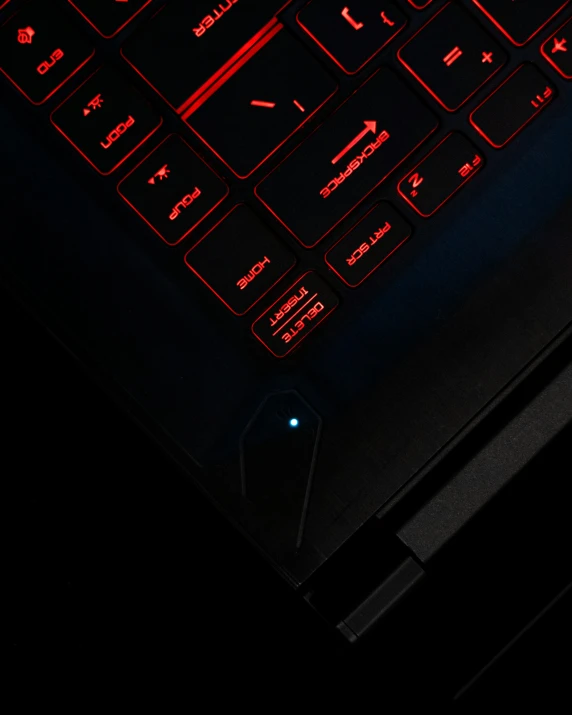 a computer keyboard lit up at night on the keyboard