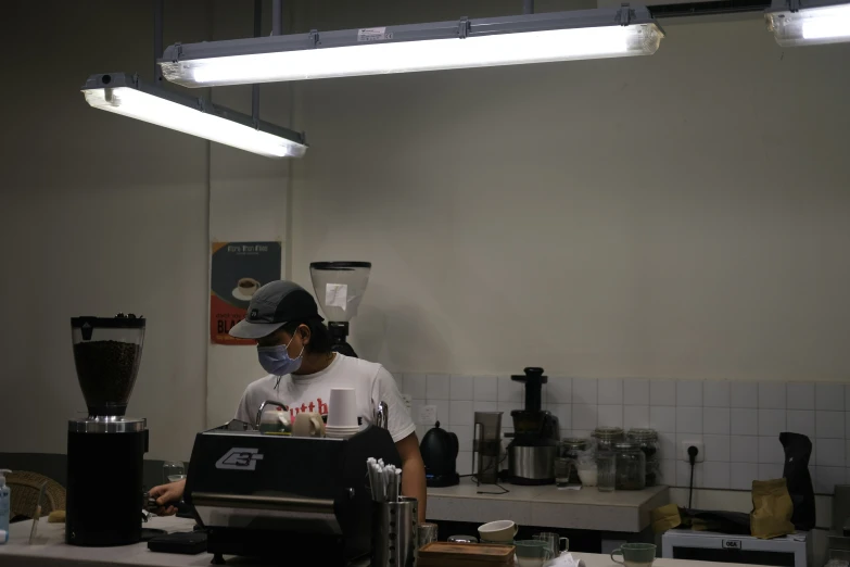 a woman using a machine in a kitchen