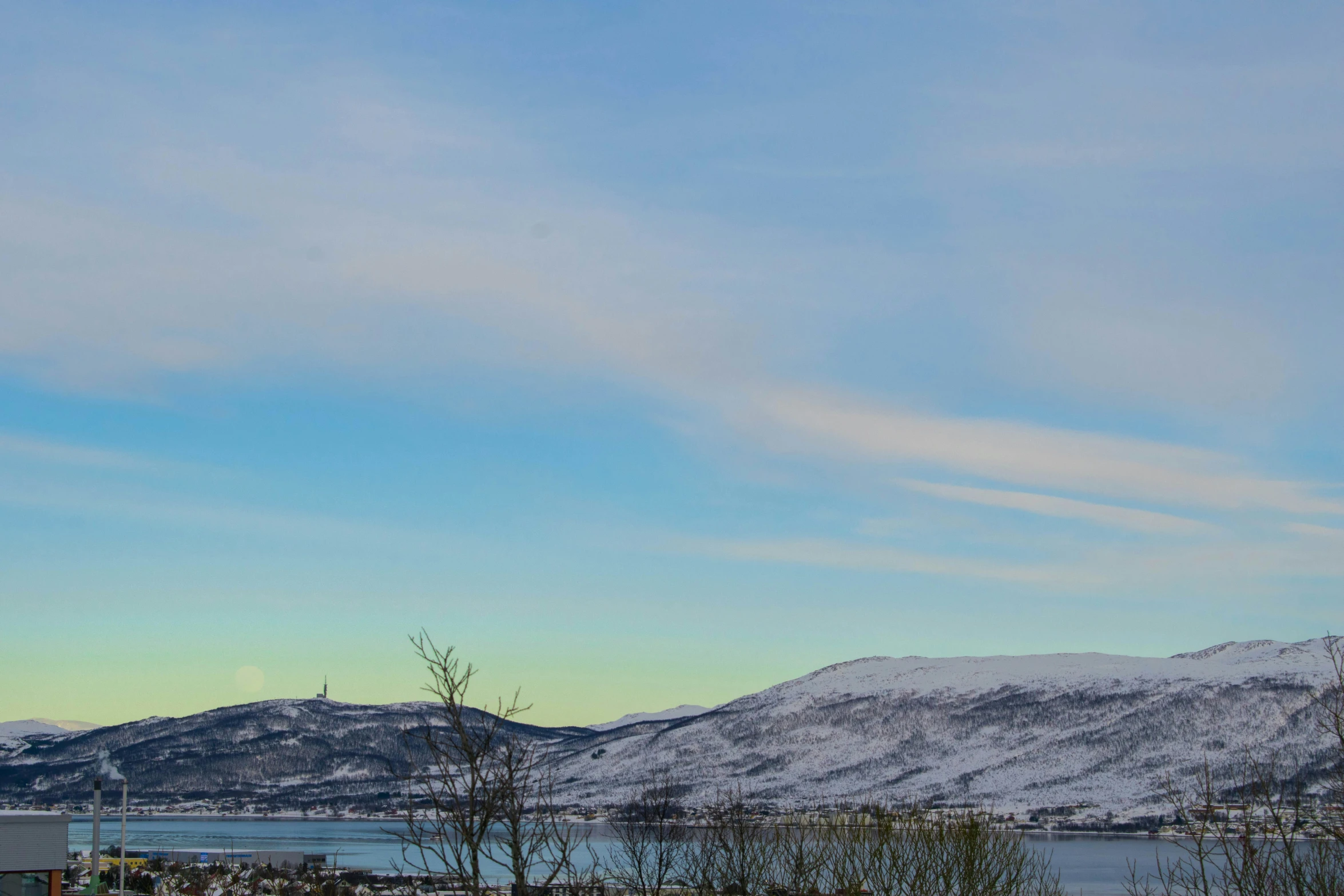 mountains are covered in snow on the horizon