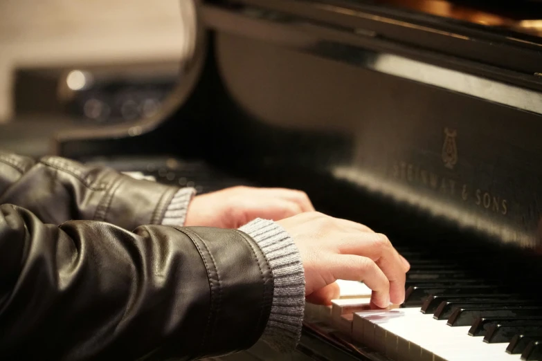 a close up of a person playing a piano