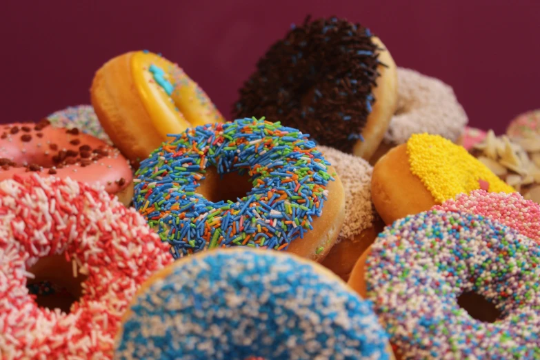 many different types of donuts in a pile