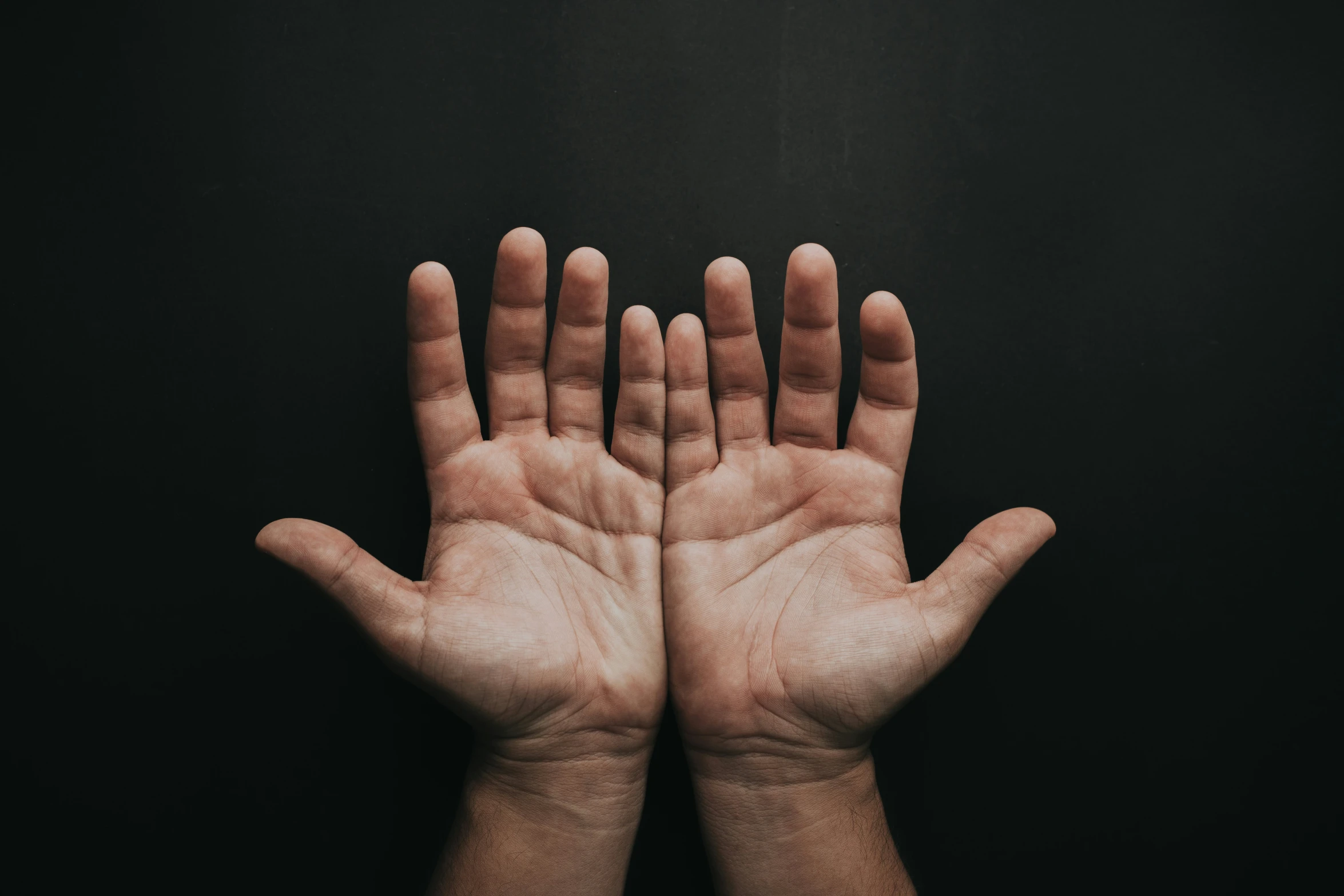 two hands are standing up with their palms closed