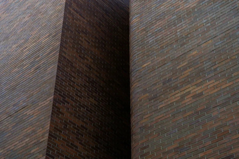 an umbrella is sticking out of a brick wall