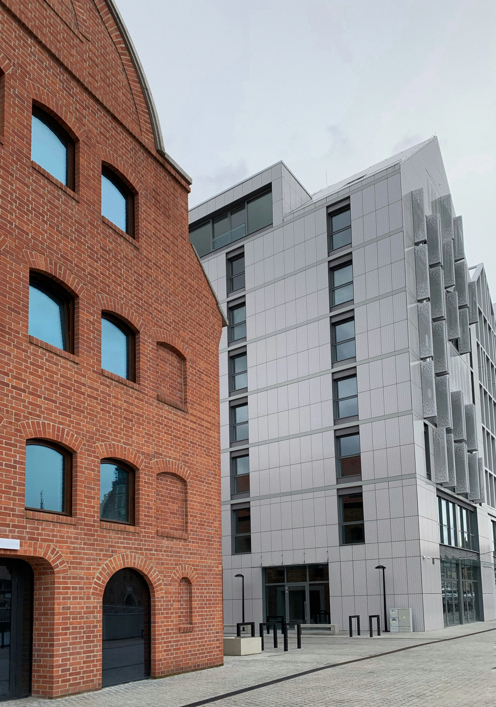 a brick building that has been designed to look like it is sitting next to another building