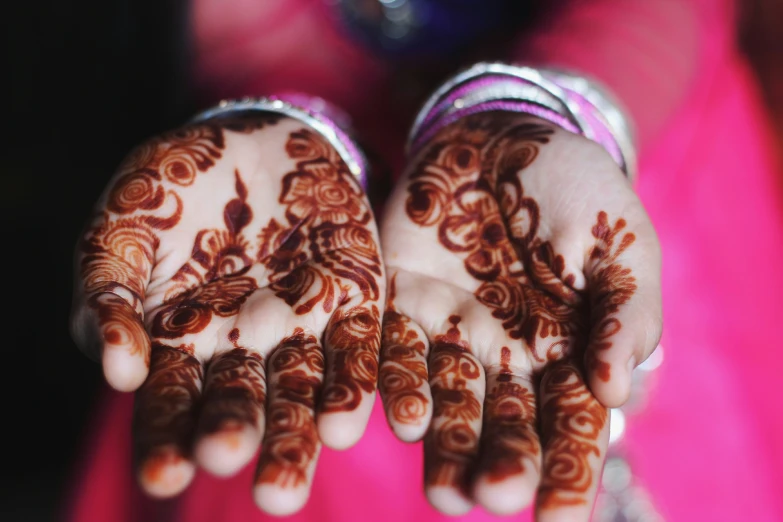 woman's hands with an intricate design in the palm