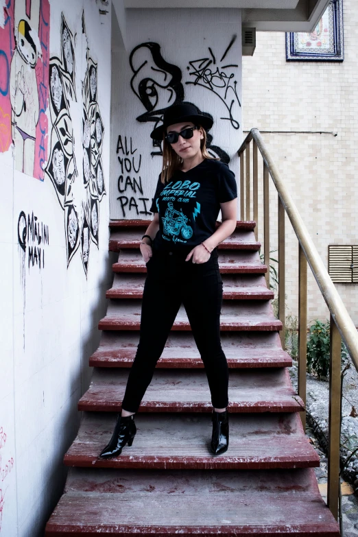 a woman standing on the steps outside of a building