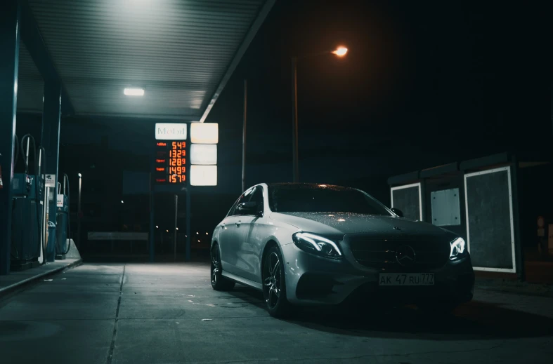 a mercedes cla parked in the parking lot at night