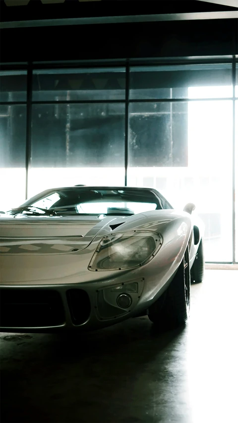 a ferrari sports car sits in front of a window