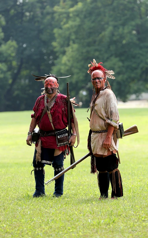 two men in costume are standing in the grass