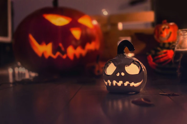 there is a jack - o'- lantern that is on the table next to a beer