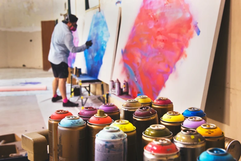 a person in an art studio painting colorful paint