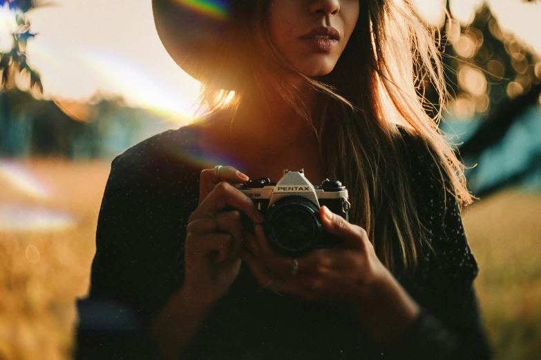 the girl is taking a picture with a camera