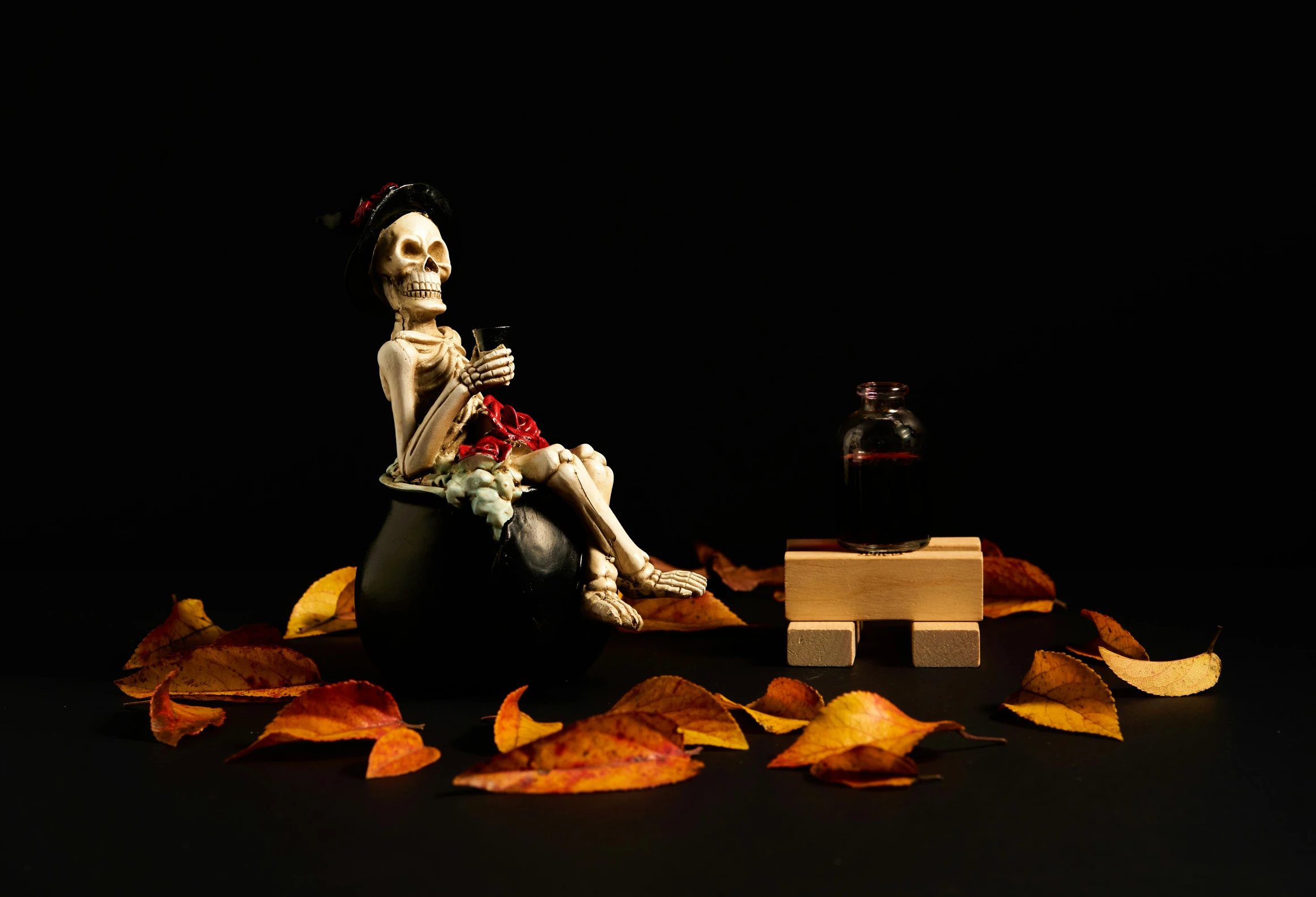 a skeleton with flowers sits on an object