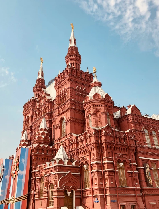 an ornate building stands behind a very tall building