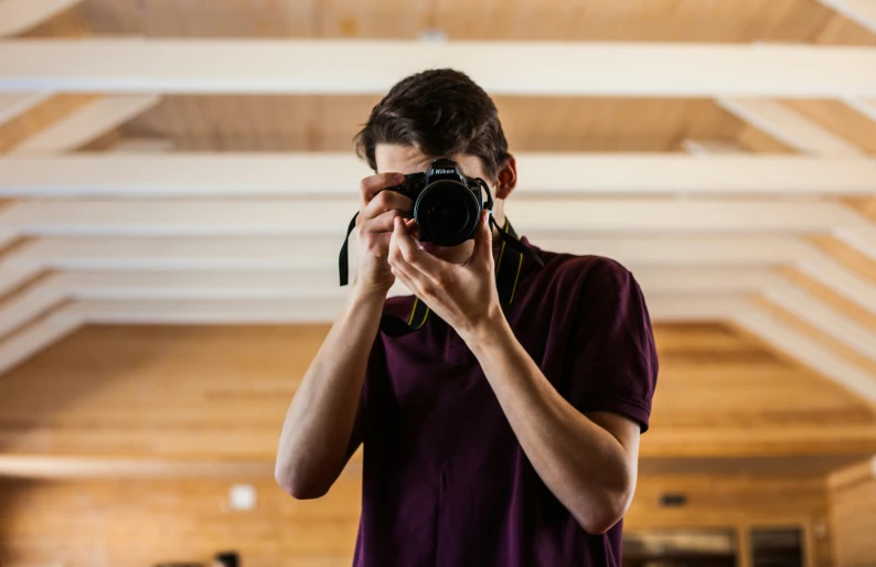 a man taking pictures with a camera in a hall