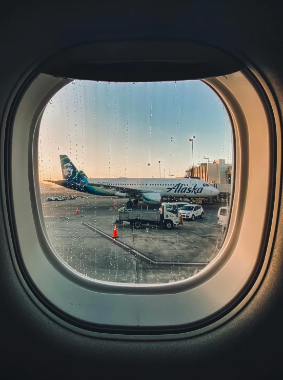 a window looking at an airport and planes