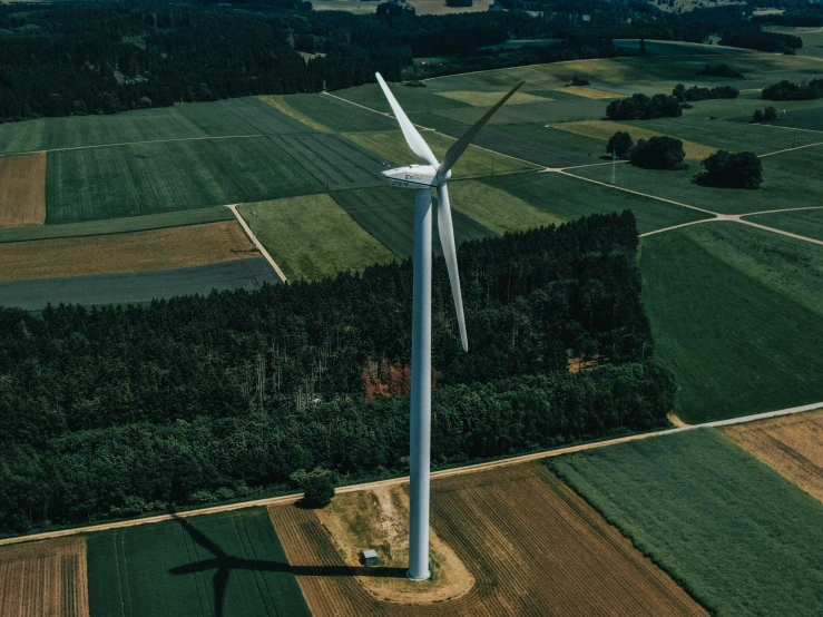 an aerial view of the wind turbine in a field