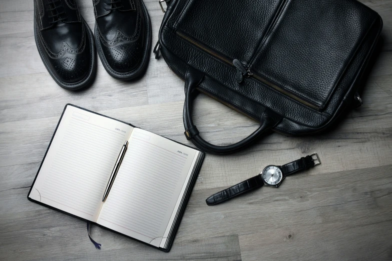 the notebook and shoes are next to a notebook