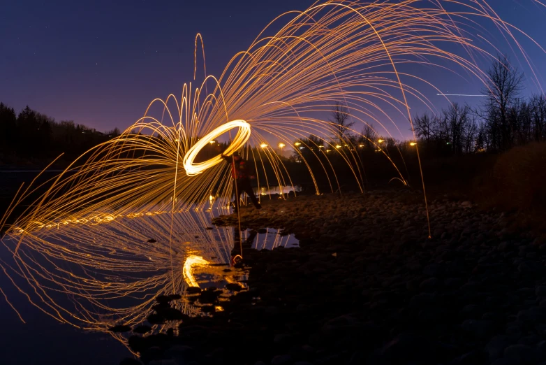 fireworks on the water as it is spinning in it's reflection