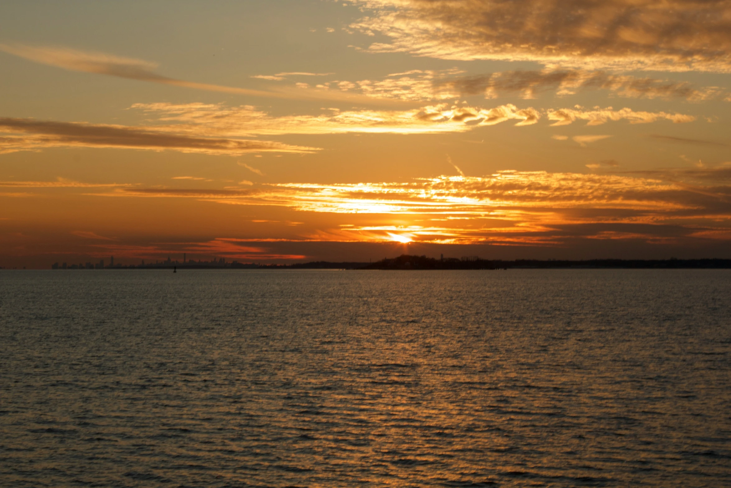 a boat is silhouetted against the sunset