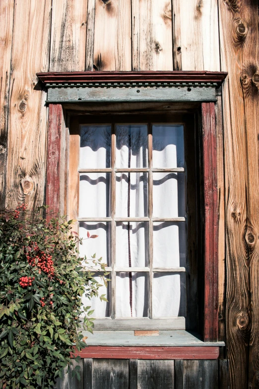 a window on the side of a building has bars on it