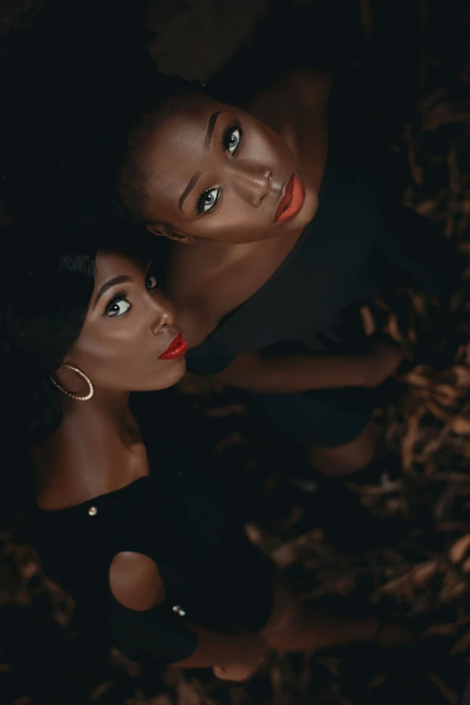 two women are sitting in the dirt