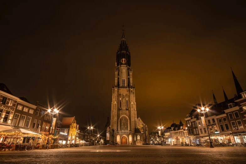 a building with a tall tower sitting in the middle of a city