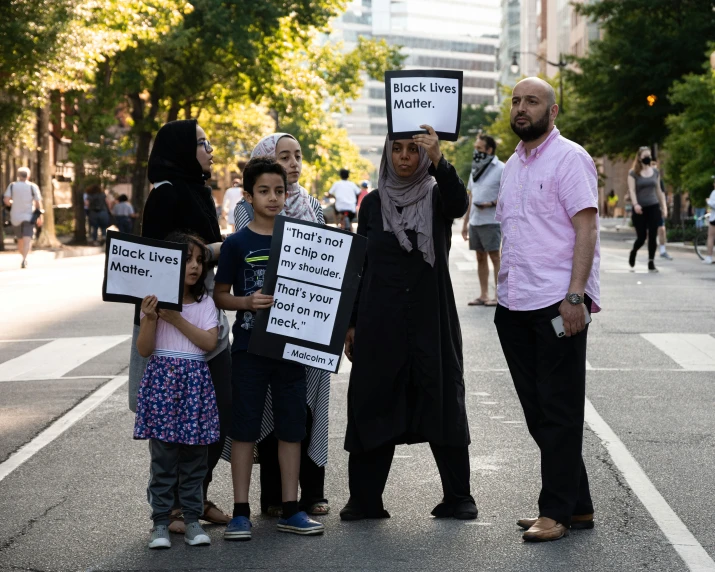 there is a group of people holding signs in the street