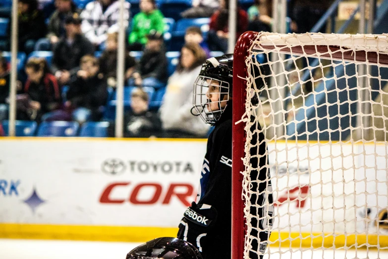 hockey goaltender preparing to make a face off on the ice