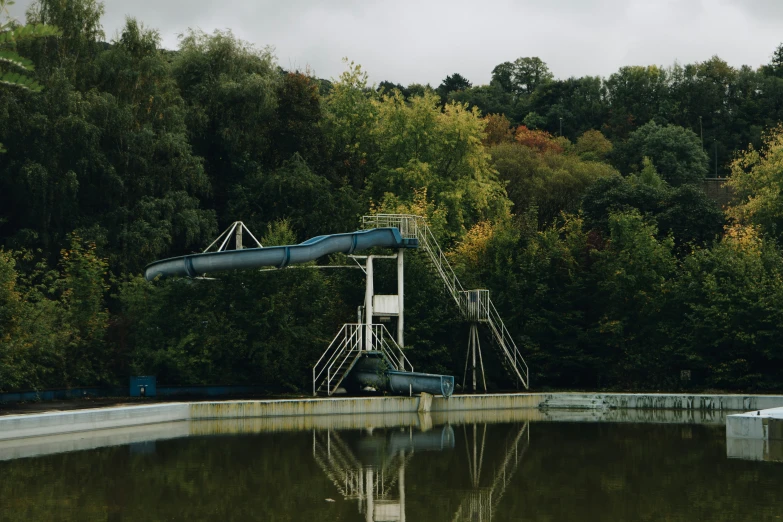 an artificial water slide at the edge of a pond